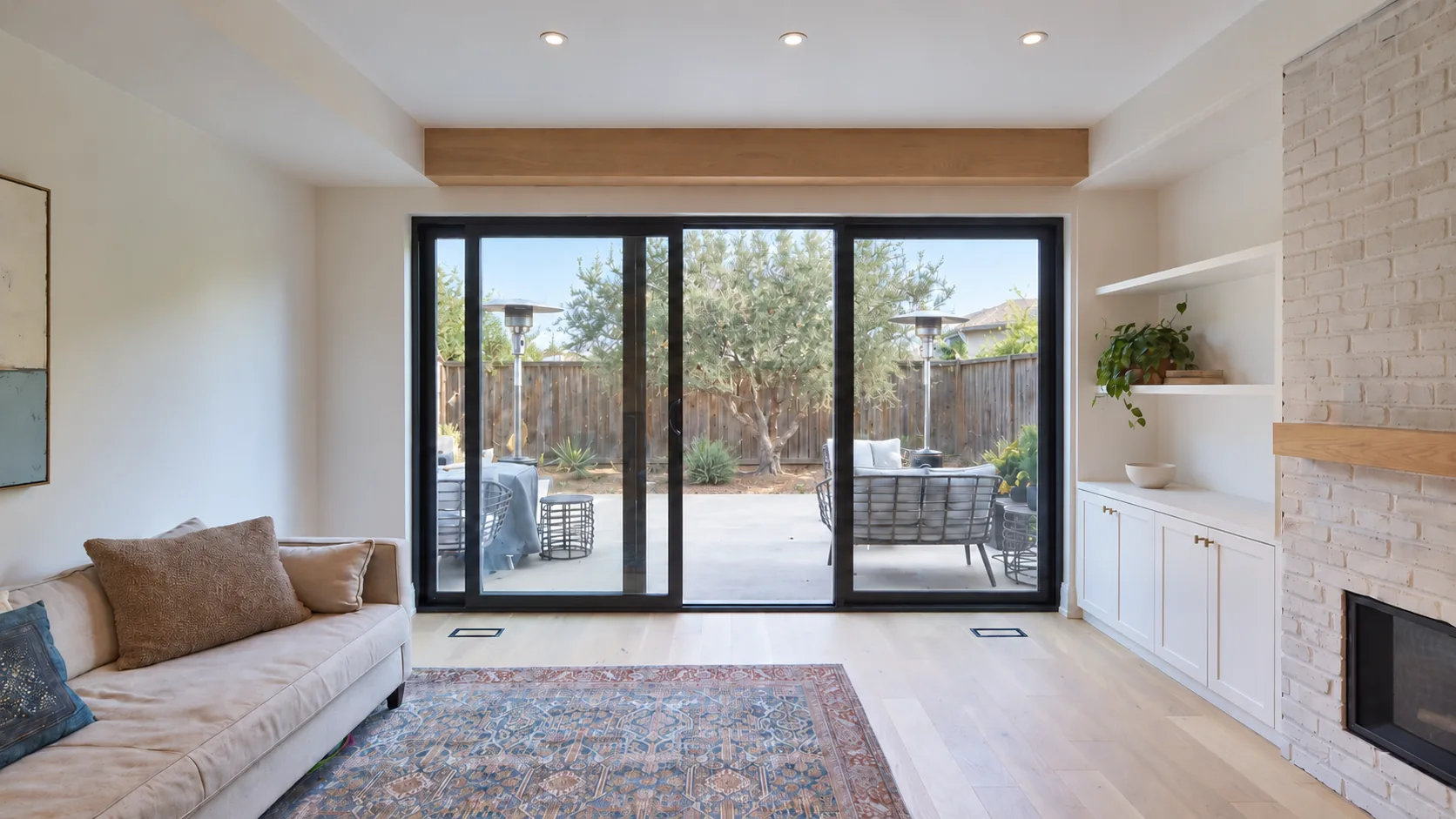 Concept image: a bright living room with a sliding door to the patio, built-in shelves and a fireplace.